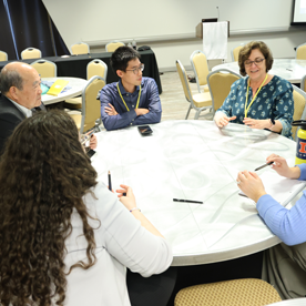 CAS Members discussing topics around a table